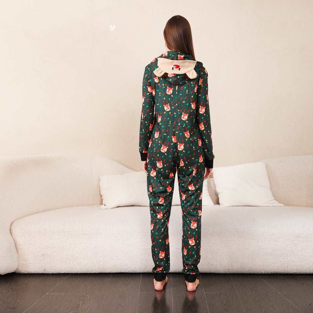 Rear view of a woman's green Christmas print onesie with a lowered reindeer face hood and black ankle cuffs.