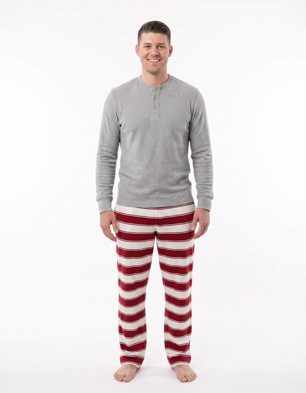 Men's matching holiday pajamas with heather grey long sleeve henley top and red striped pants