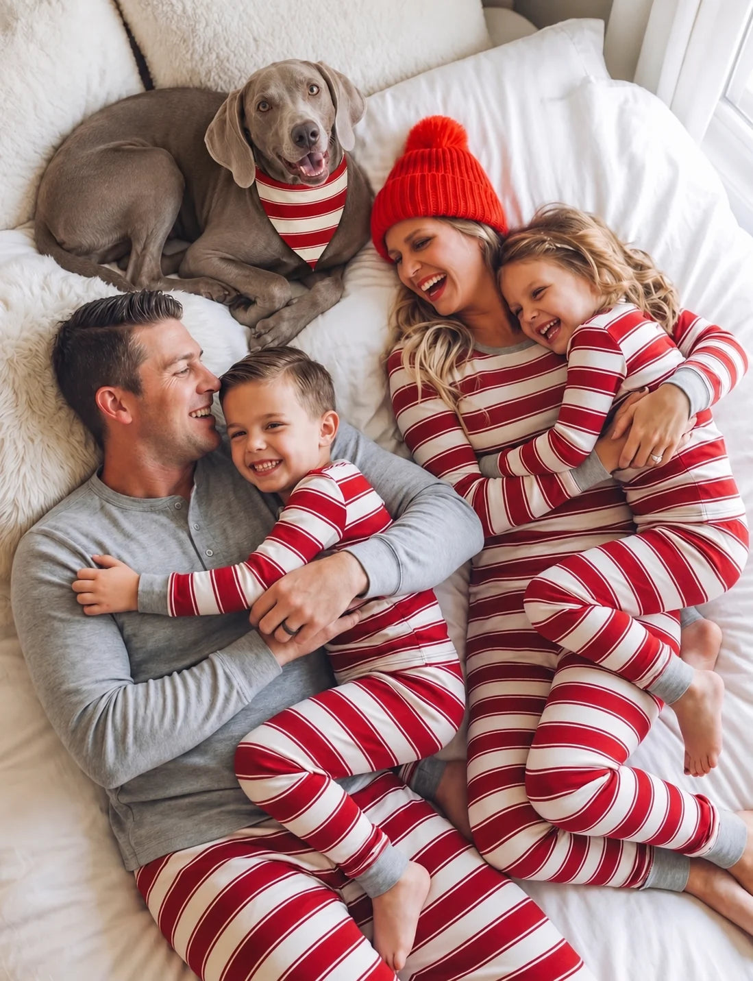 Family in red and white striped pajamas with a gray Henley top on the man, and a dog in a striped bandana.