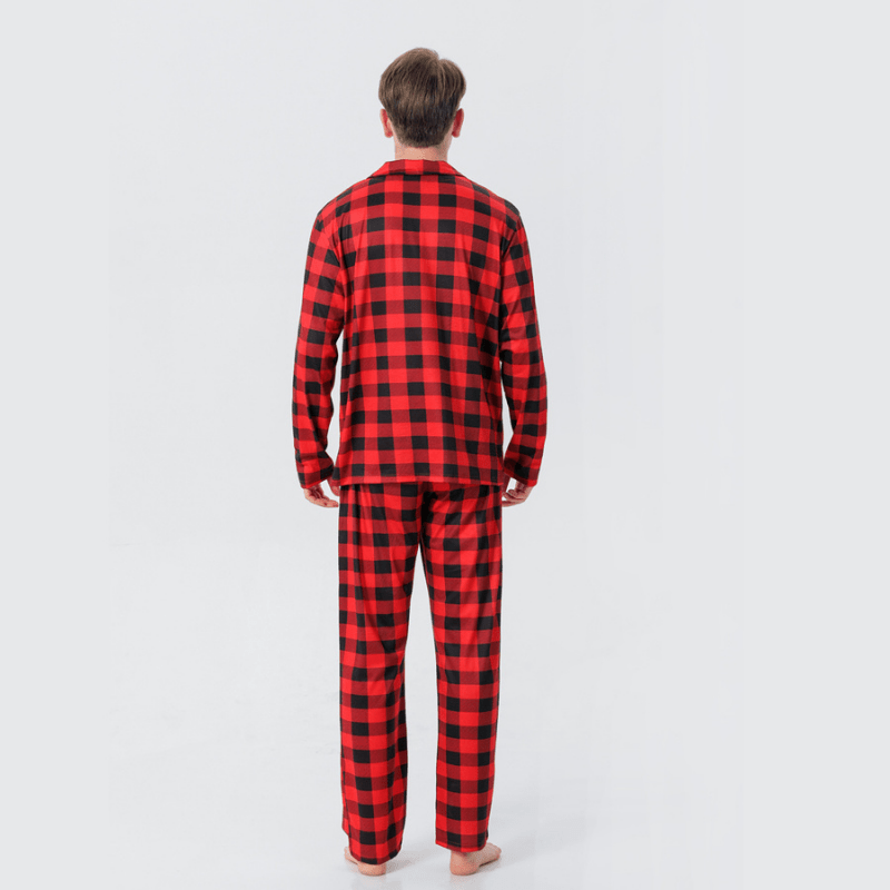 Rear view of a man wearing red and black buffalo plaid button-front pajamas.