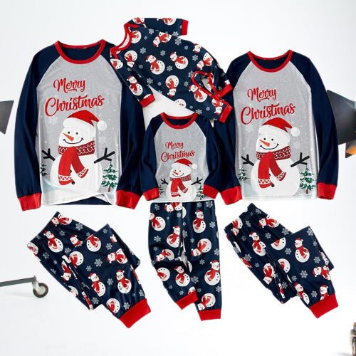 Flat lay of gray-and-navy Merry Christmas snowman pajama tops, printed pants and a matching baby romper.