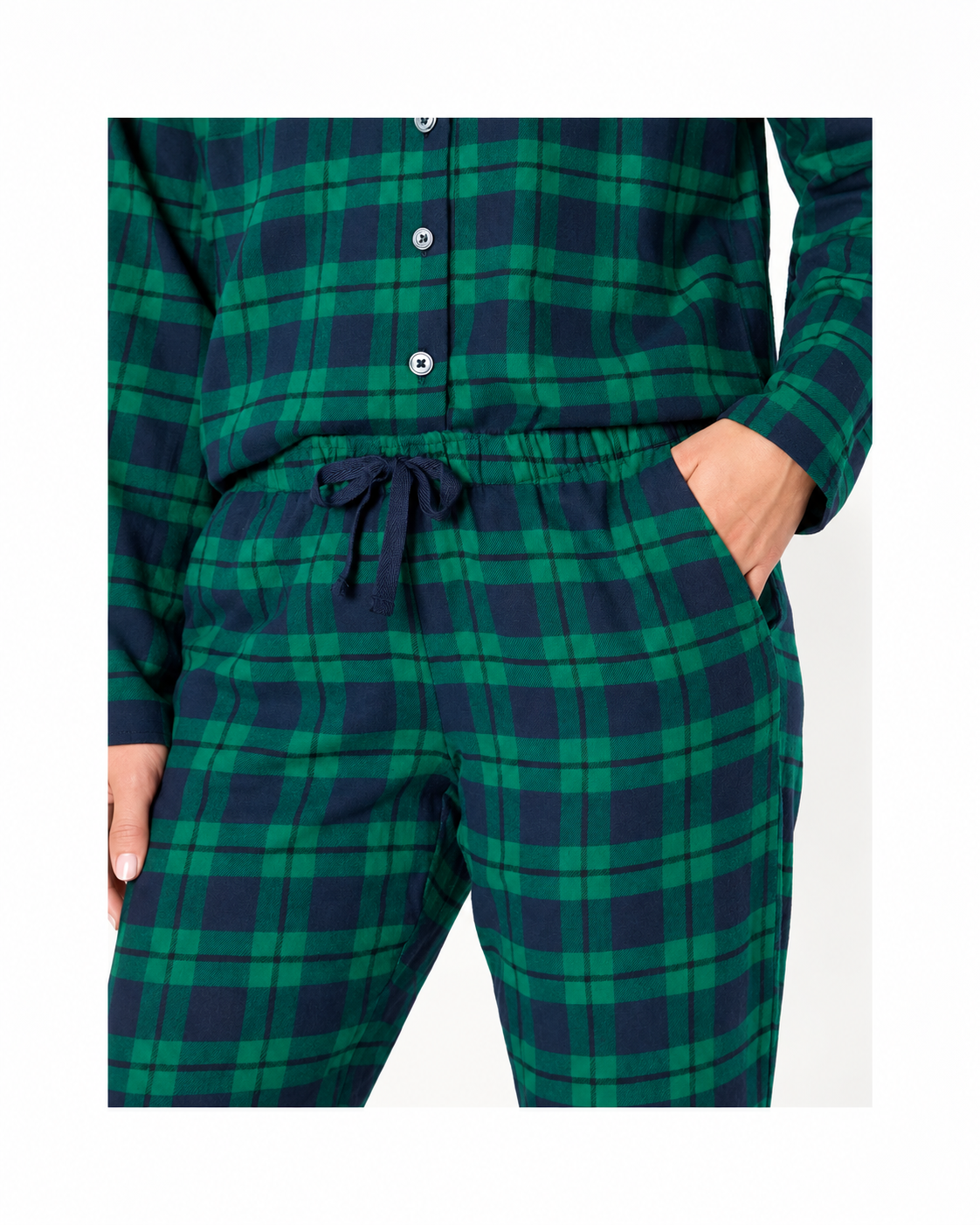 Close-up of forest green and navy plaid pajama pants showing the drawstring waist and side pocket.
