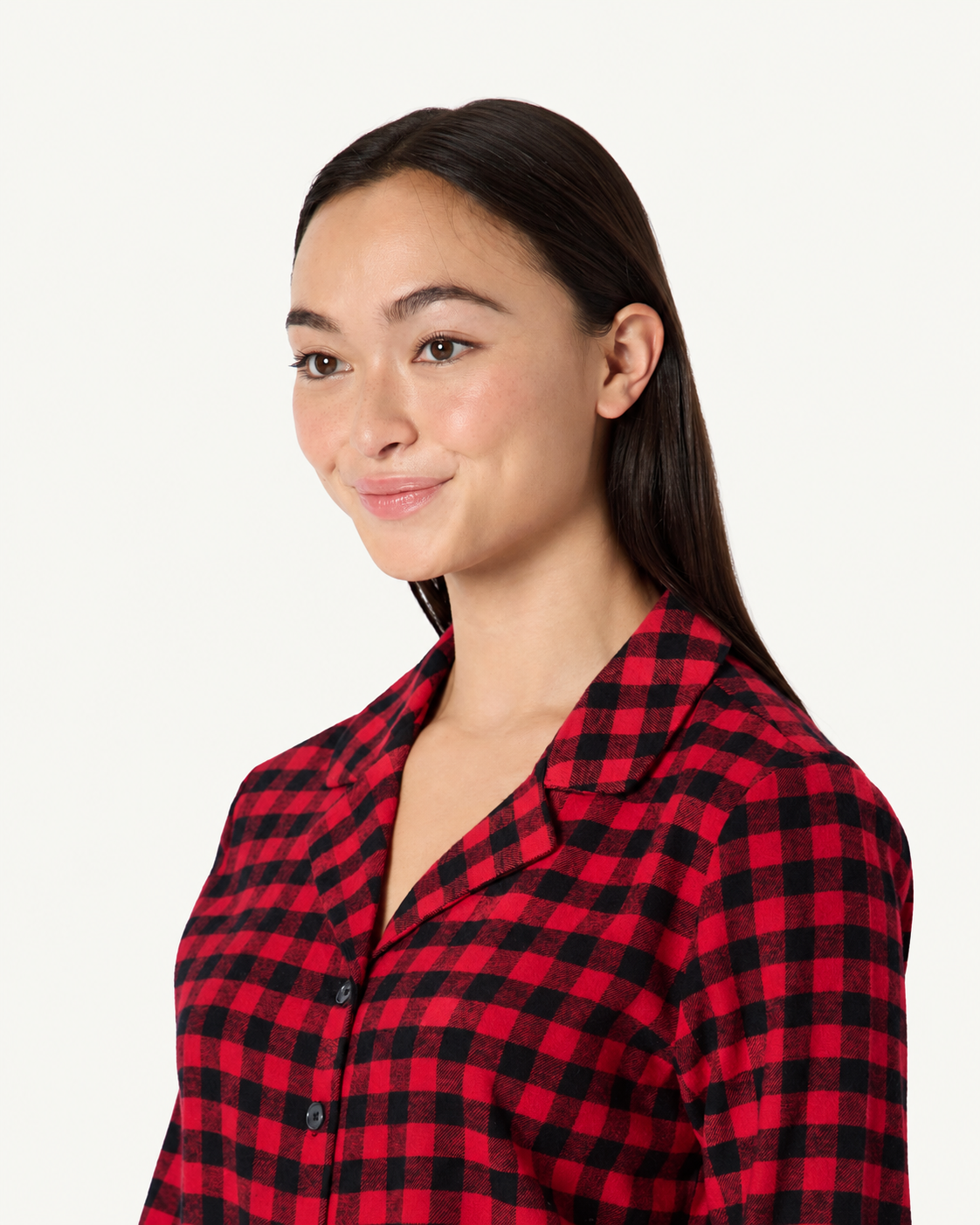 Close-up of a red and black check pajama shirt showing the notched collar and button-front neckline.