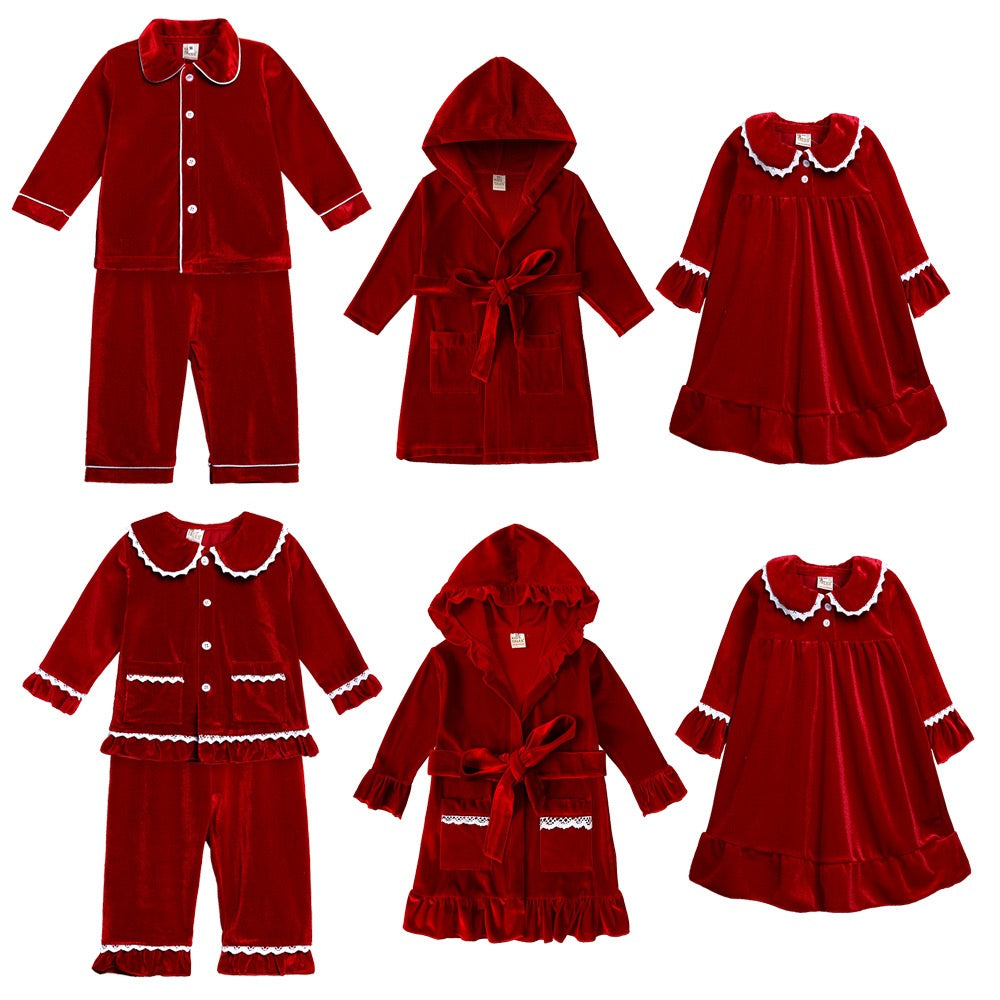 Flat lay of red family sleepwear including button-front pajamas, hooded robes and nightdresses with white trim.