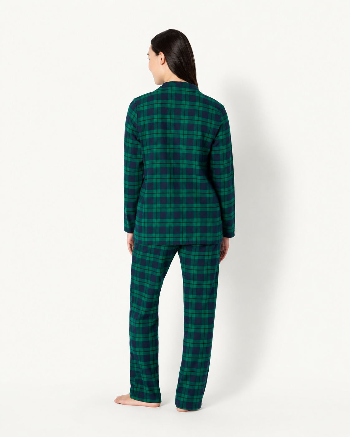 Back view of a woman wearing a forest green and navy plaid long-sleeve pajama shirt and matching pants.