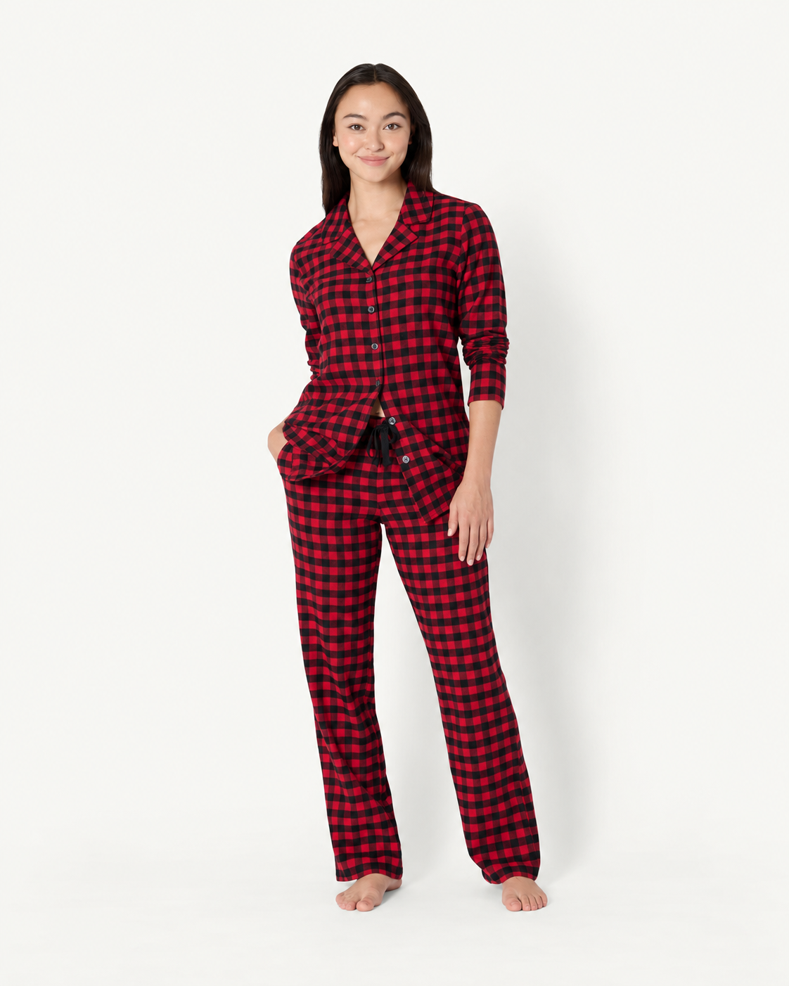 Woman wearing red and black check pajamas with a collared button-front shirt and drawstring pants.