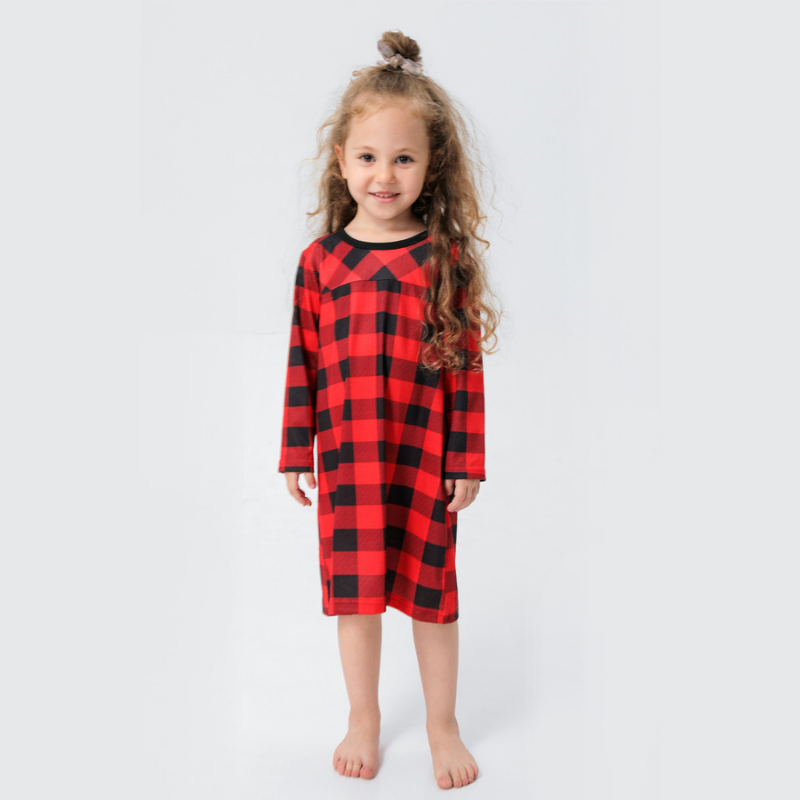 Girl modeling a red and black buffalo plaid long-sleeve nightdress against a white background.