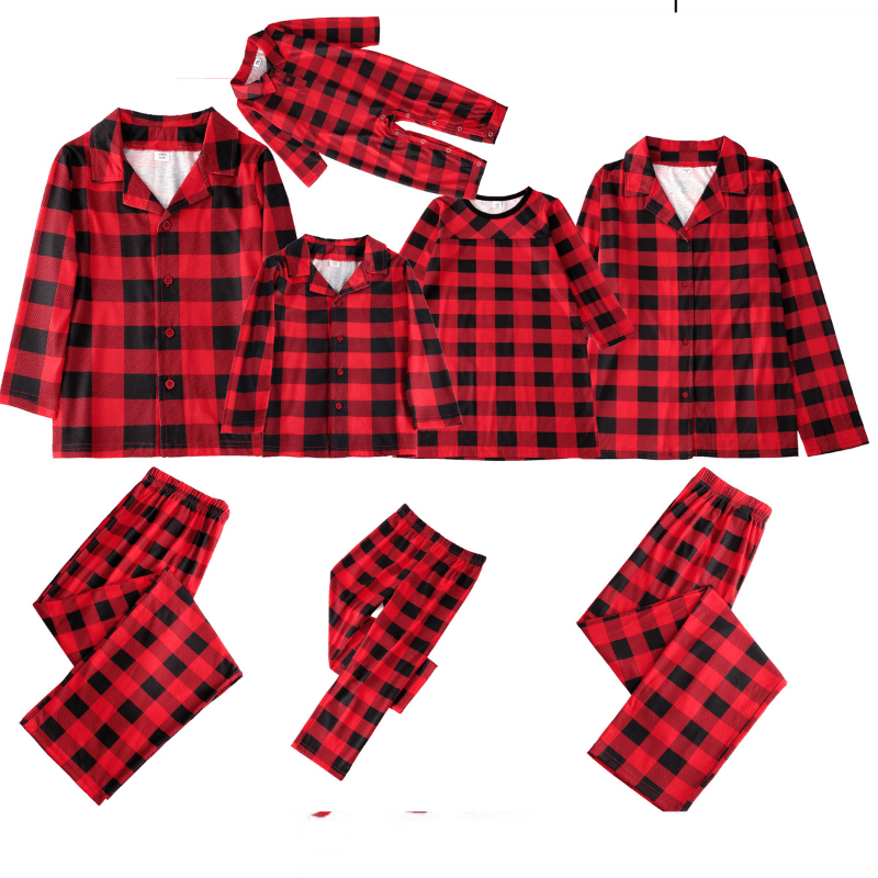 Flat lay of red-and-black buffalo plaid pajama tops, pants and a baby romper.